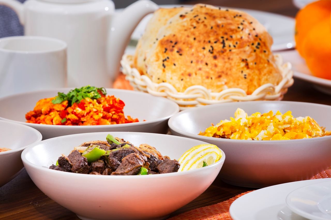 Delicious assortment of colorful dishes in bowls with bread, perfect for a food-centered stock photo.